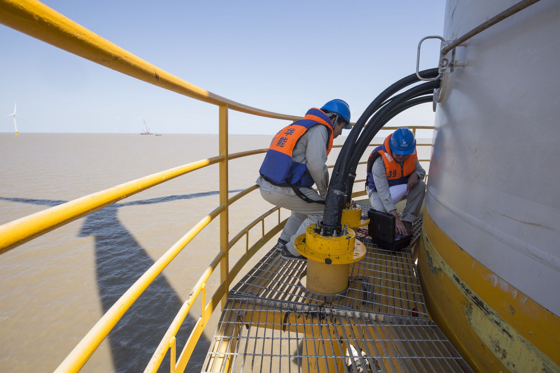 Technicians working at an offshore energy site