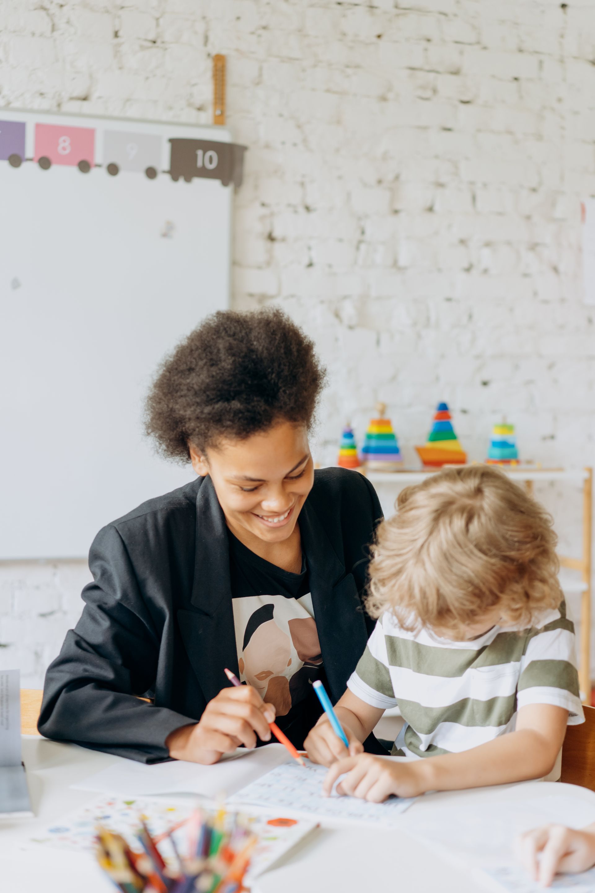 An educator working one-to-one with a pupil in a classroom