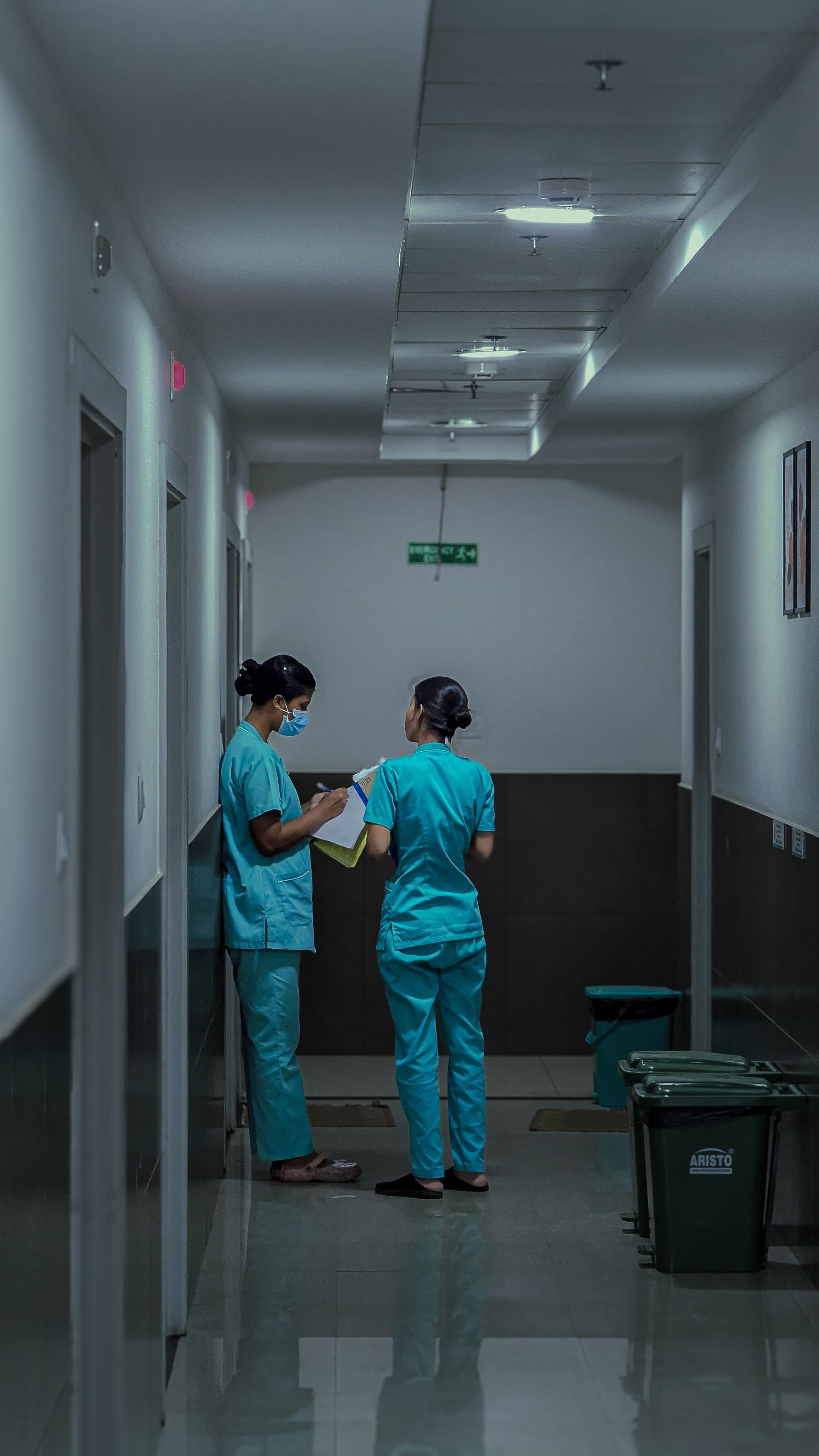 Healthcare professionals walking through a hospital corridor